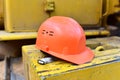 Red construction helmet. Headwear to protect the head of the worker when performing hazardous building work. Safety concept at the