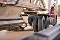 Red truck pulling white construction belly dump on highway