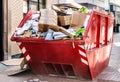 Red Container filled with cardboard Trash