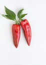 Red ``Corno di Toro`` Peppers with Leaves on White Background