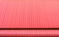 Red corrugated metal sheets roofs