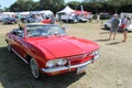 Red Corvair convertible driving on lawm