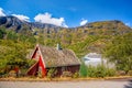 Red cottage against cruise ship in fjord, Flam, Norway