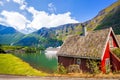 Red cottage against cruise ship in fjord, Flam, Norway Royalty Free Stock Photo