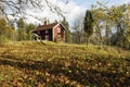 Red cottage and autumn leaves Royalty Free Stock Photo