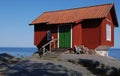 Red cottage by sea Royalty Free Stock Photo