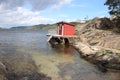 Red cottage by sea Royalty Free Stock Photo