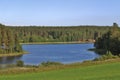 Red cottages by a calm lake in Norrbotten