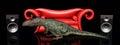 Red couch, loudspeaker boxes and the dinosaur Giganotosaurus Royalty Free Stock Photo