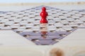 Red counter on Chinese checkers board Royalty Free Stock Photo