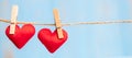 Red couple heart shape decoration hanging on line with copy space for text on blue wooden background. Love, Wedding, Romantic and Royalty Free Stock Photo