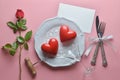 Red couple heart, wine opener, cocktail glass on white dish, with fork and knife in ribbon, Rose , On pink background. Royalty Free Stock Photo