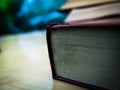 Red cover book of bottom side spine on the wood table.