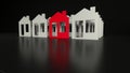 Red cozy house in front of group of white houses on black background with reflections. Real estate investment concept.