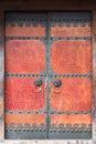 Red cracked paint chinese traditional door with door knockers Royalty Free Stock Photo