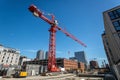 Red crane on construction site under blue sky Royalty Free Stock Photo