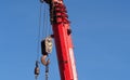 Red crane  works in construction site  with hooks Royalty Free Stock Photo