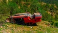 Red crashed car on the grass in the mountains Royalty Free Stock Photo