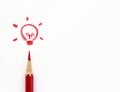 Red crayons drawing light bulb