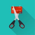 Red credit card cutting by the scissors.