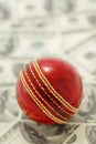 Red Cricket Ball and Money Royalty Free Stock Photo