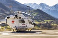 Red Cross medic MD Helicopter MD Explorer by McDonnell Douglas Helicopter Systems stands on heliport