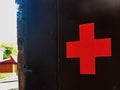 Red cross on wooden background