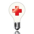 Red cross symbol in the light bulb