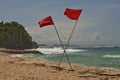 Red crossed flags on the beach mean a prohibition to swim