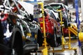 A red crossover is standing on a transport tape at a car factory. Car manufacturing. Royalty Free Stock Photo