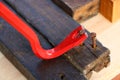 Red crowbar pulling a rusty nail Royalty Free Stock Photo