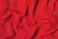 Red crumpled nonwoven fabric on a green Royalty Free Stock Photo