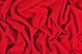 Red crumpled nonwoven fabric on a green Royalty Free Stock Photo