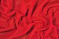 Red crumpled nonwoven fabric on a green Royalty Free Stock Photo