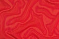 Red crumpled nonwoven fabric on a green Royalty Free Stock Photo