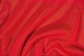 Red crumpled nonwoven fabric on a green Royalty Free Stock Photo