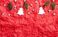 Red crumpled silk paper background with Christmas decorations on upper section. Royalty Free Stock Photo