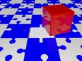 Red cube on puzzle pieces in blue and white colors Royalty Free Stock Photo