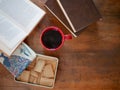 Beverages. Red mug with coffee, cookies in a box  and books. Royalty Free Stock Photo