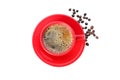 Red cup of coffee with coffee beans isolated on white background, top view Royalty Free Stock Photo