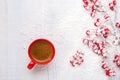 Red cup of coffee and branches with hawthorn berries on an old white wooden background. Flat lay Royalty Free Stock Photo
