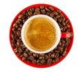 Red cup with espresso on saucer with coffee beans isolated on white. Top view Royalty Free Stock Photo