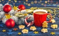 Red cup of coffee, gingerbread and snowy branch of Christmas tree with Christmas decorations Royalty Free Stock Photo