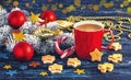 Red cup of coffee, gingerbread and snowy branch of Christmas tree with Christmas decorations Royalty Free Stock Photo