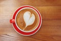 Red cup of coffee with heart shaped latte art Royalty Free Stock Photo