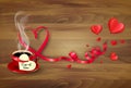 Red cup of coffee with a heart shaped valentine note and red heart shape ribbon. Valentine`s Day background. Royalty Free Stock Photo