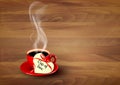 Red cup of coffee with a heart shaped valentine note Royalty Free Stock Photo