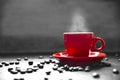 Red cup coffee with smoke and coffee bean on wood table, Drinking concept, selective red color Royalty Free Stock Photo