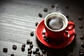 Red cup coffee with stream vapor and coffee bean on wood table