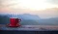 Red cup with coffee on table over mountains landscape Royalty Free Stock Photo